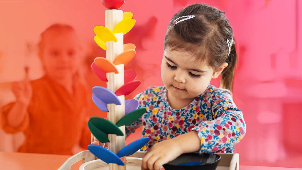 Photo of a young student playing with a toy