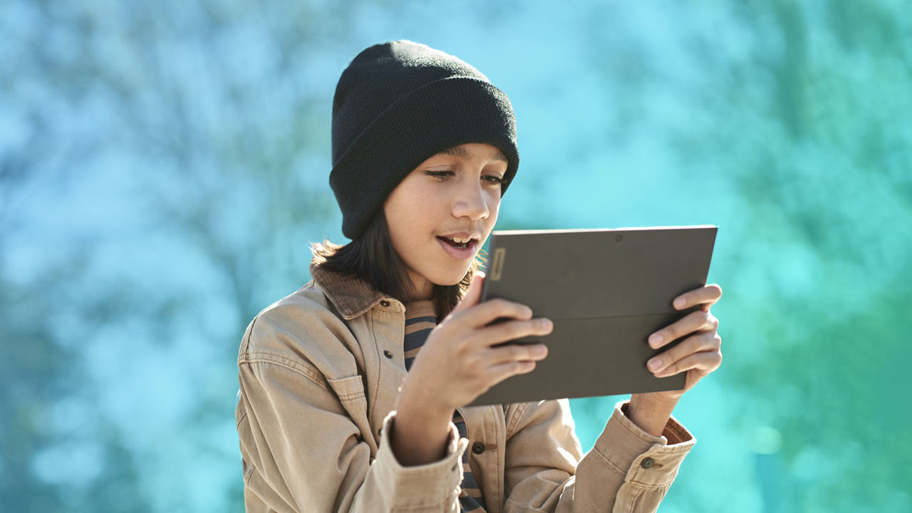 Student learning on tablet outside